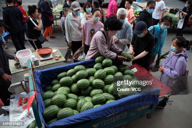 People purchase watermelons at a market on May 31, 2023 in Shenyang, Liaoning Province of China.