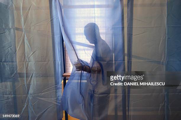 Romanian tourist gets out from a polling booth at one of the additional polling stations, which have been set up along the Black Sea coast to...