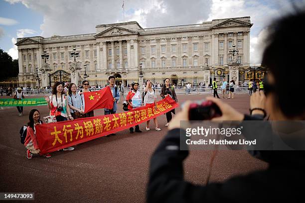 Chinese tourists have their pictures taken outside Buckingham Palace on July 29, 2012 in London, England. Today the womens road race takes over the...
