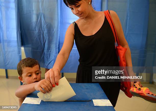 Romanian tourist casts her ballot at one of the additional polling stations which have been set up along the Black Sea coast to facilitate voting for...