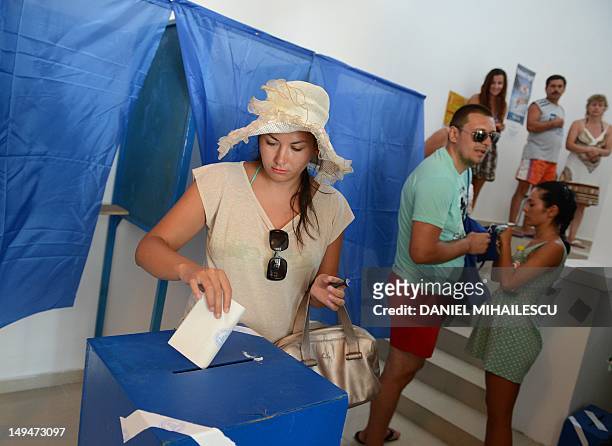 Romanian tourist casts her ballot at one of the additional polling stations which have been set up along the Black Sea coast to facilitate voting for...