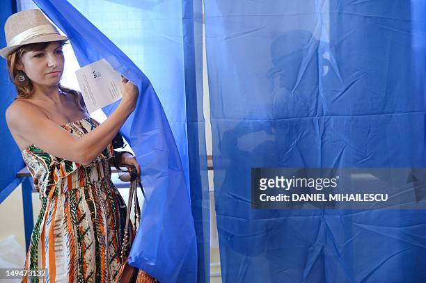 Romanian tourist gets out of a polling booth at one of the additional polling stations which have been set up along the Black Sea coast to facilitate...