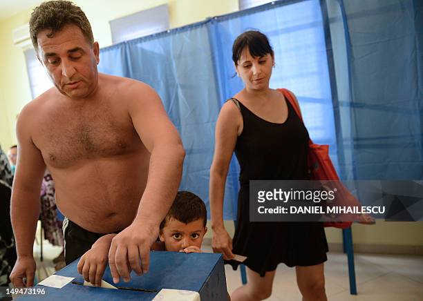 Romanian tourist casts his ballot at one of the additional polling stations which have been set up along the Black Sea coast to facilitate voting for...