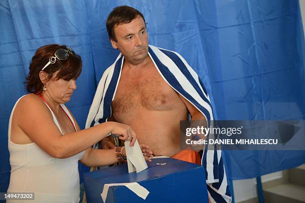 Romanian tourists cast their ballot at one of the additional polling stations which have been set up along the Black Sea coast to facilitate voting...