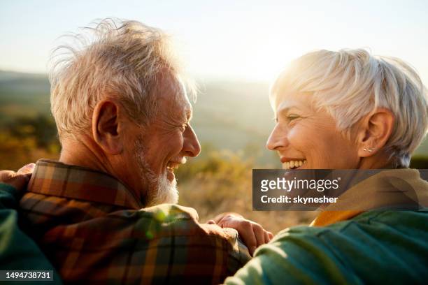 happy senior couple talking during autumn day in nature. - like stock pictures, royalty-free photos & images