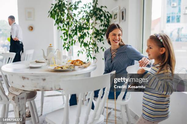 the cute little girl finished her lunch and got up from the table in the restaurant - eating pesto stock pictures, royalty-free photos & images