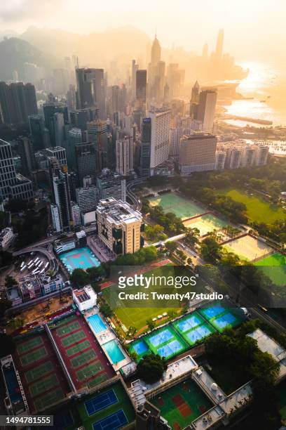 aerial view of sport field in the residential district against skyscrapers in hong kong city - causeway bay stockfoto's en -beelden