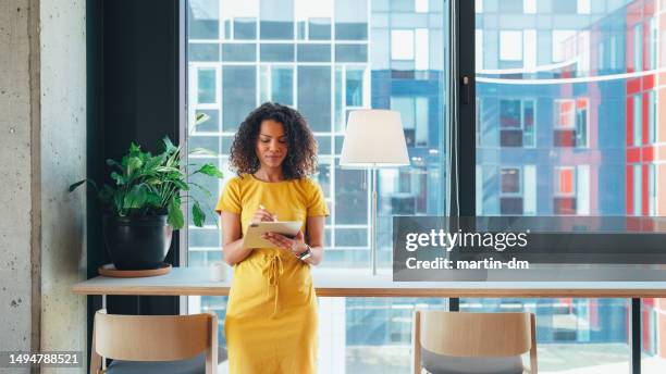 businesswoman in coworking space - signing tablet stock pictures, royalty-free photos & images