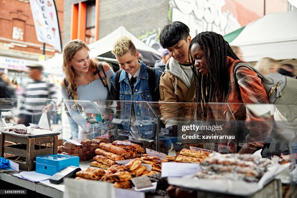 Hungry Londoners checking out food at market stall