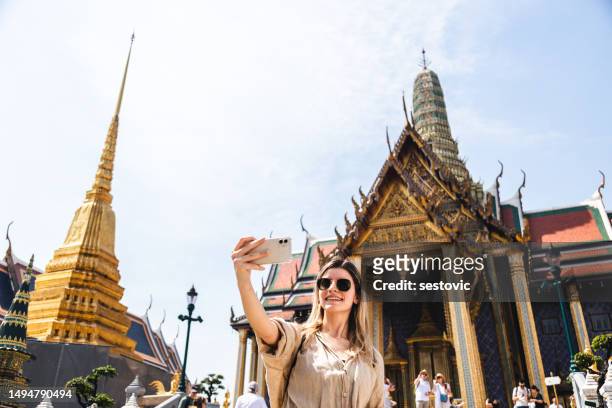 young woman exploring the grand palace in bangkok - bangkok tourist stock pictures, royalty-free photos & images