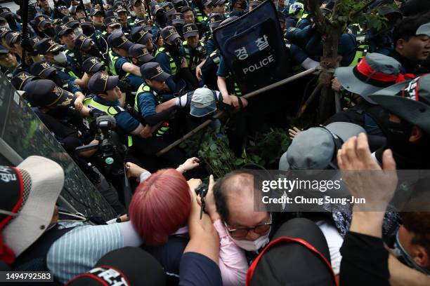 Labour union members from the Korean Confederation of Trade Unions scuffle with policemen during a rally in central Seoul in protest of the...