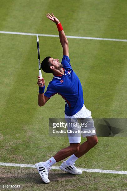 Novak Djokovic of Serbia serves during the Men's Singles Tennis match against Fabio Fognini of Italy on Day 2 of the London 2012 Olympic Games at the...