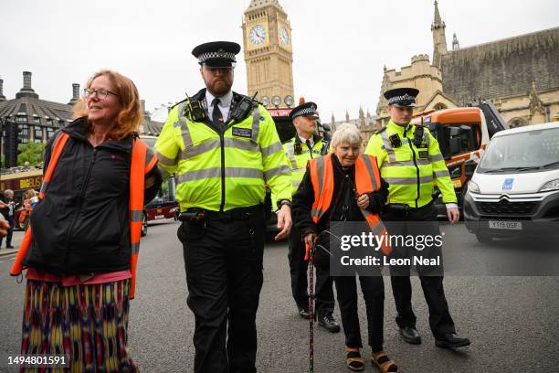 Two women are arrested after joining a group of environmental campaigners from the Just Stop Oil group in a slow procession around Parliament Square...