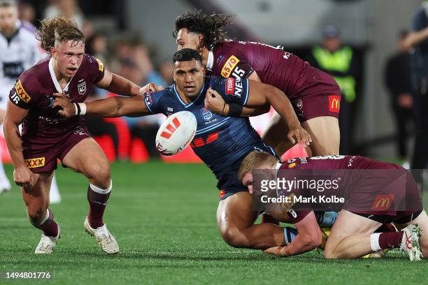 Tevita Pangai Junior of the Blues offloads during game one of the 2023 State of Origin series between the Queensland Maroons and New South Wales...