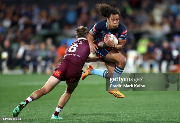 Jarome Luai of the Blues is tackled by Cameron Munster of the Maroons during game one of the 2023 State of Origin series between the Queensland...