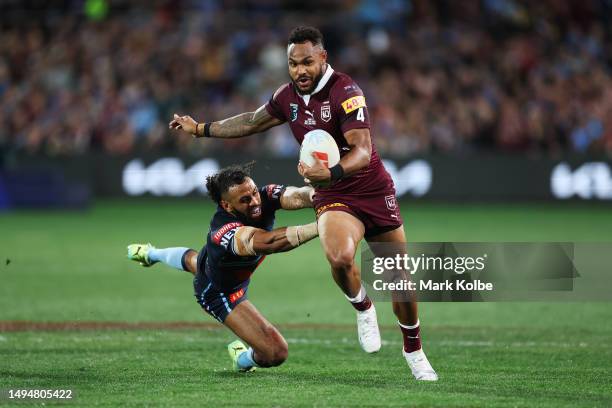 Hamiso Tabuai-Fidow of the Maroons beats the tackle of Josh Addo-Carr of the Blues before scoring a try during game one of the 2023 State of Origin...