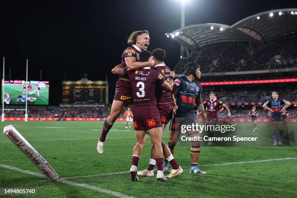 Selwyn Cobbo of the Maroons celebrates with team mates after scoring a try during game one of the 2023 State of Origin series between the Queensland...