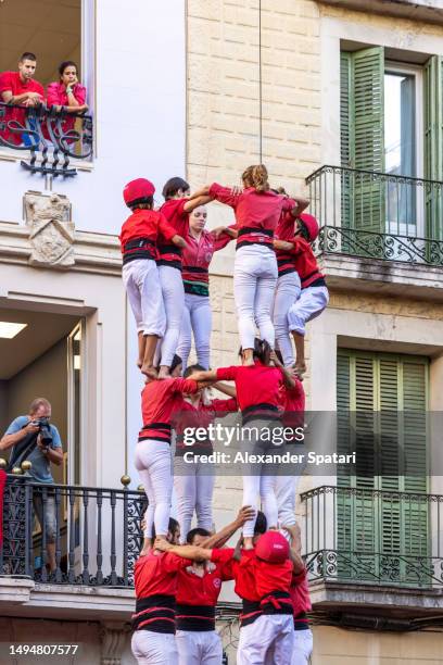castells human towers competition during festa major de gracia celebrations in barcelona, catalonia, spain - castell stock pictures, royalty-free photos & images