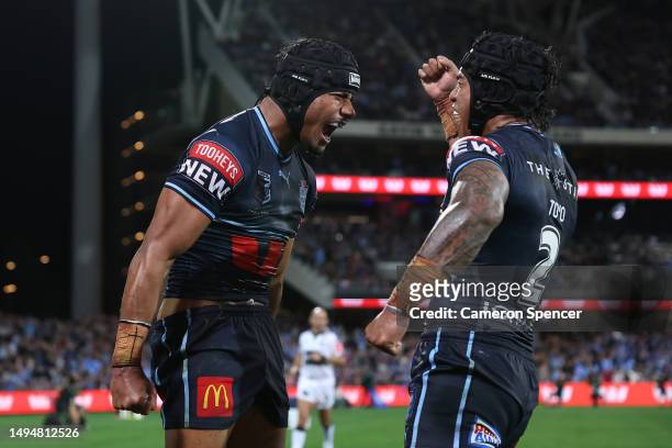 Stephen Crichton of the Blues celebrates with Brian To'o of the Blues after scoring a try during game one of the 2023 State of Origin series between...