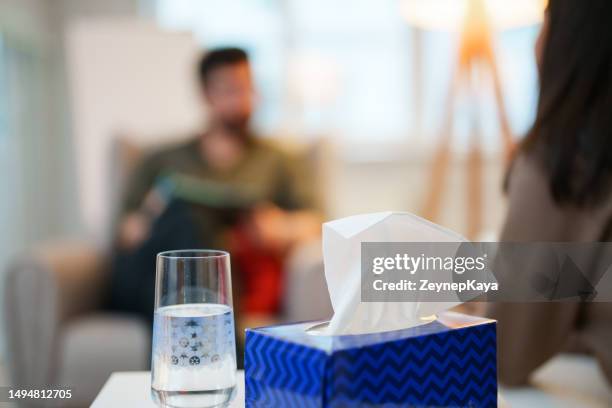 close up to a glass of water and tissue box - tissue box stockfoto's en -beelden