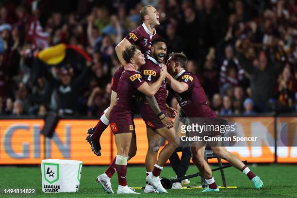 Hamiso Tabuai-Fidow of the Maroons celebrates with team mates after scoring a try during game one of the 2023 State of Origin series between the...