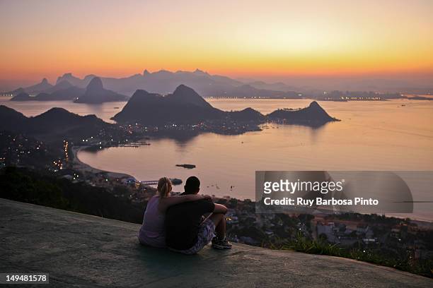 couple admiring sunset - brazil ocean stock-fotos und bilder