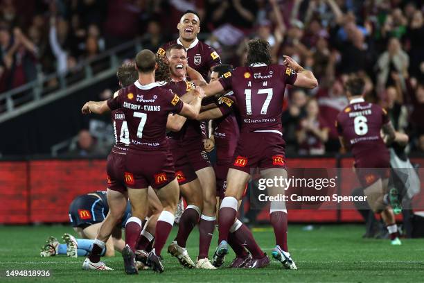 Lindsay Collins of the Maroons celebrates with team mates after Cameron Munster of the Maroons scored a tryduring game one of the 2023 State of...