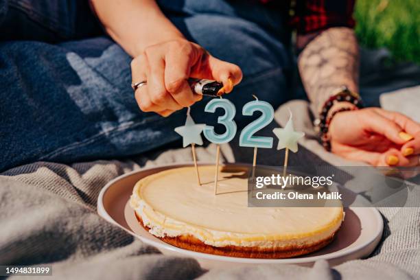 birthday celebration. woman holding a birthday cake with candles - birthday candle number stock pictures, royalty-free photos & images