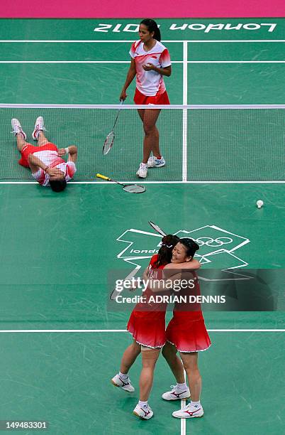 Japan's Reika Kakiiwa and Mizuki Fujii celebrate after winning the women's doubles badminton match against Singapore's Shinta Mulia Sari and Yeo Lee...