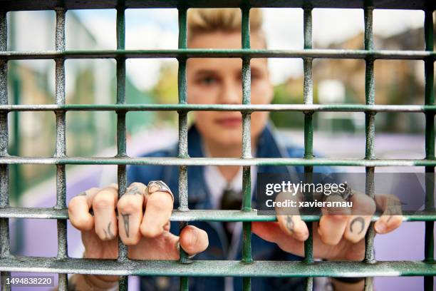 tattooed fingers on urban sports fence - human face people grid stock pictures, royalty-free photos & images