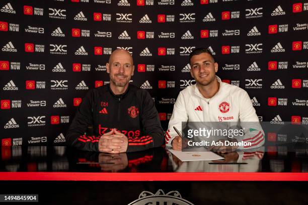 Diogo Dalot of Manchester United poses with Manager Erik ten Hag after signing a new contract with the club at Carrington Training Groundon May 31,...