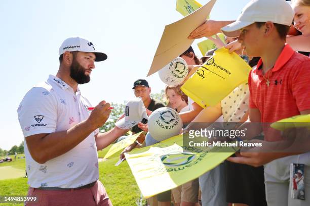 Jon Rahm of Spain signs autographs for fans after playing a practice round prior to the Memorial Tournament presented by Workday at Muirfield Village...