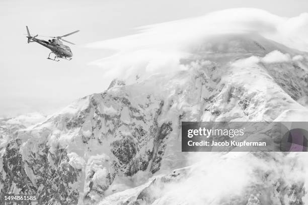 mount foraker in alaska, as seen from denali, with a helicopter in the foreground - フォーレイカー山 ストックフォトと画像