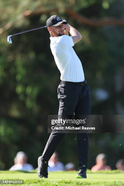 Stephen Curry of the Golden State Warriors plays his shot from the sixth tee during the Golden Bear Pro-Am prior to the Memorial Tournament presented...