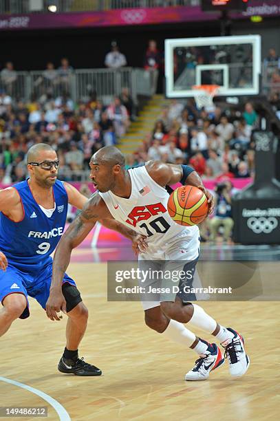 Kobe Bryant of the USA Mens Senior National team drives against Tony Parker of France at the Olympic Park Basketball Arena during the London Olympic...