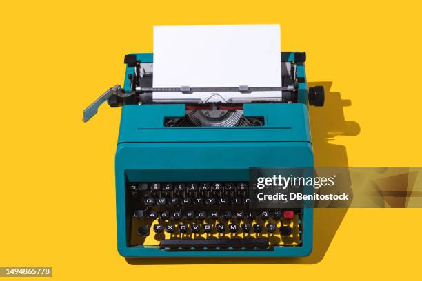 green retro typewriter, with a blank page, on a yellow background. concept of writing, writer, writing, news, literature and culture. - literature stock pictures, royalty-free photos & images