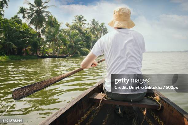 tourist man floating on alleppey backwaters and enjoying beautiful - backwater stock pictures, royalty-free photos & images