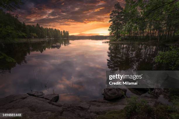 lake with stunning cloud reflections at sunrise. midsummer in mantyharju, finland, northern europe - finnish nature stockfoto's en -beelden