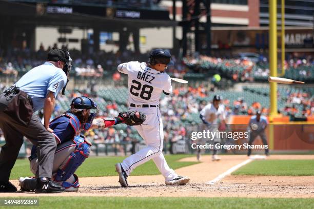 Javier Baez of the Detroit Tigers breaks his bat on a ground ball to short stop that scored a run in the third inning in front of Jonah Heim of the...