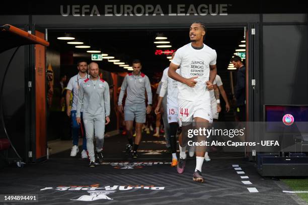 Loic Bade of Sevilla FC warms up wearing a t-shirt in support of Sergio Rico of Paris Saint-Germain, after they suffered a head injury, prior to the...