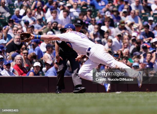 Patrick Wisdom of the Chicago Cubs catches the fly out by Taylor Walls of the Tampa Bay Rays during the third inning of a game at Wrigley Field on...