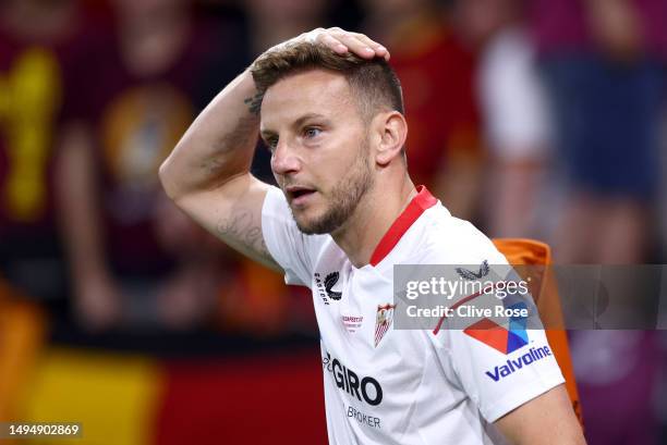 Ivan Rakitic of Sevilla FC covers their head as they prepare to take a corner in front of fans of AS Roma during the UEFA Europa League 2022/23 final...