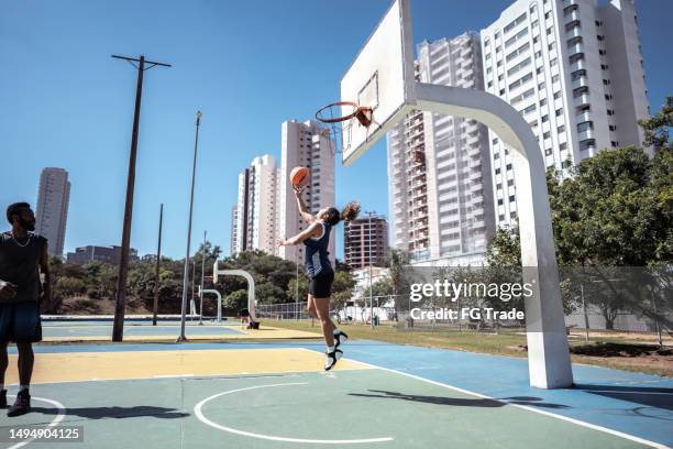 friends playing basketball on a sport court - spring city break stock pictures, royalty-free photos & images