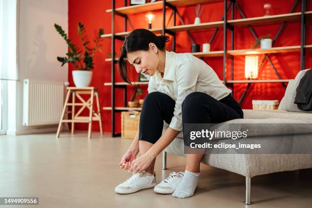 frau ist schnürsenkel binden. - anziehen stock-fotos und bilder