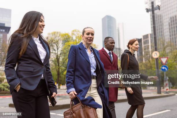 meeting moments: sophisticated professionals conversing in frankfurt's business hub - innovation hub stock pictures, royalty-free photos & images