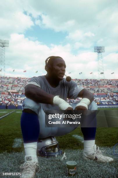 Running Back Barry Sanders of the Detroit Lions sits on his helmet and conducts a post-game interview after the game between the Detroit Lions vs the...