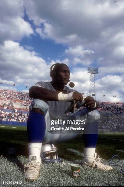 Running Back Barry Sanders of the Detroit Lions sits on his helmet and conducts a post-game interview after the game between the Detroit Lions vs the...