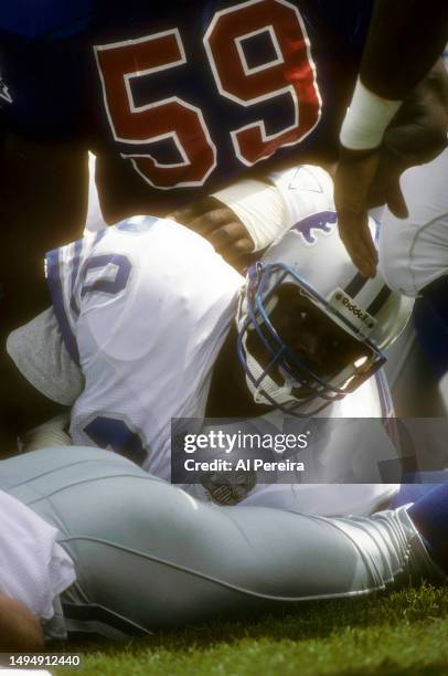 Running Back Barry Sanders of the Detroit Lions looks up after being tackled in the game between the Detroit Lions vs the New England Patriots at...