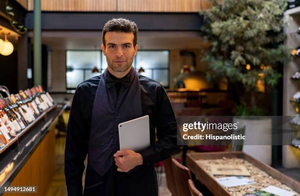 portrait of a restaurant host holding a tablet - wine tasting online stock pictures, royalty-free photos & images