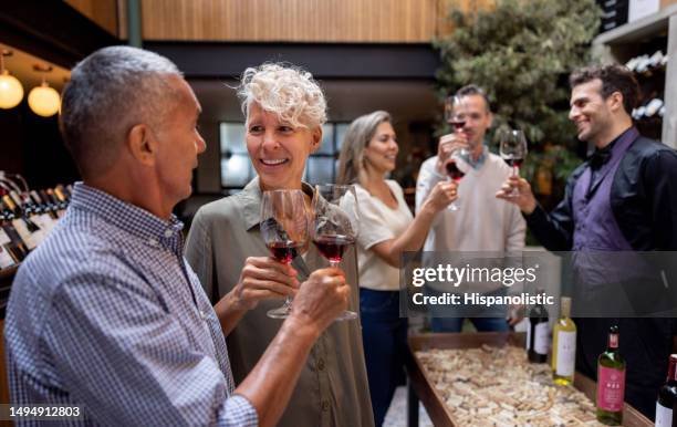 happy couple making a toast at a wine tasting - wijn proeven stockfoto's en -beelden